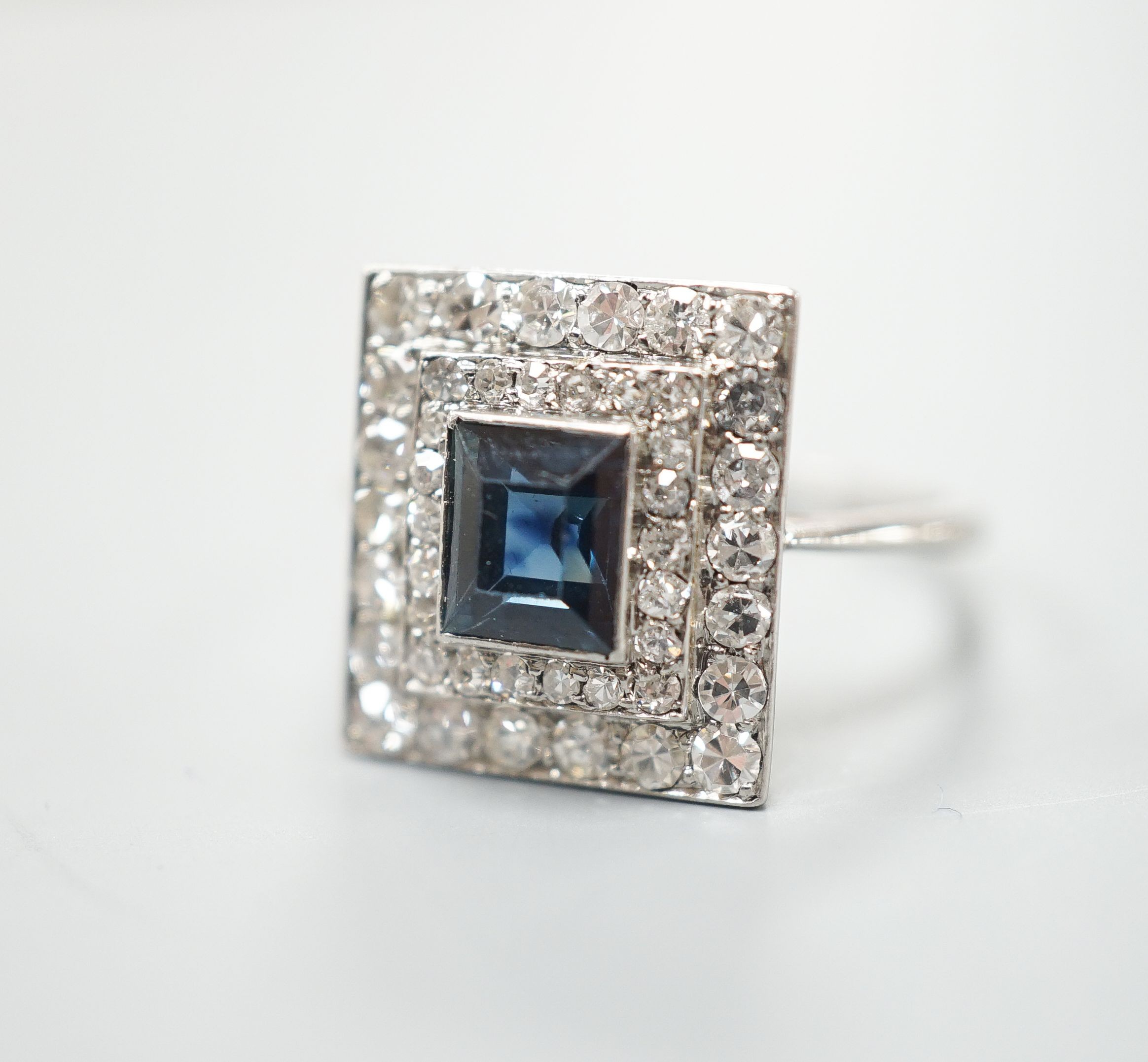 A white metal, sapphire and diamond set square cluster ring, size N, gross weight 4.2 grams.